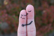 Fingers art of displeased couple. Woman cries, man reassures her. He kisses and hugs her.