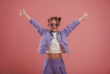 Fototapeta Na ścianę - Smiling, with hands up and on the sides. Cute little girl is against pink background