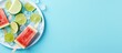 A close up image of a refreshing ice cream popsicle on a plate accompanied by watermelon slices an ice cube and a lime The blue background adds to the vibrant top view aesthetic