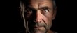 © vxnaghiyev - A middle aged man with light eyes is portrayed against a black background in the copy space image