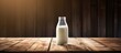 Copy space image of vintage milk bottle resting on a rustic wooden tabletop