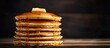© vxnaghiyev - A tall stack of pancakes perfect for a family breakfast with a shallow depth of field and an empty area for additional content