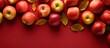 Top view of a vibrant autumn pattern consisting of numerous red apples on a colorful background A fresh apple is positioned above offering ample copy space for design elements or text