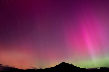 Aurora Australis over Puketapu mountain in Palmerston, Otago. Palmerston is located in the South Island of New Zealand, where the southern lights can sometimes be seen. 