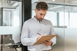 © ADDICTIVE STOCK - Professional man writing notes in modern coworking space