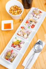 Wall Mural - several dishes sit on a white rectangular plate with two spoons