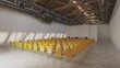 Symmetrical rows of yellow chairs in a hall, ready for an event