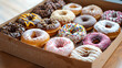 © Iqra Iltaf - Colorful donuts arranged in a box. Festive sweets