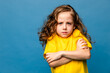 Negative human emotions, reactions and feelings. Isolated shot of moody upset little girl crossing arms on her chest, pouting lips, having offended facial expression, being capricious