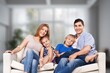 © BillionPhotos.com - Positive young family with kid taking on cozy couch