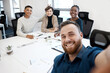 © peopleimages.com - Man, smile and selfie with people in office for portrait with business team posing, picture and together for social media. Happy, staff and photographer with support, trust and fun for memory