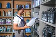 © Serhii - man with canister of motor oil in auto store
