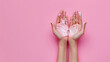 © Katerina - Woman's hands apply moisturizer cream on pastel pink background with copyspace. Skincare concept.
