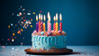 © lisssbetha - Blue Birthday cake with different colored candles on the light blue background