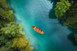 Aerial view of a lonely boat floating on a vivid turquoise lake