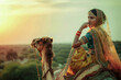 © Niks Ads - Indian woman posing with camel animal