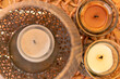 Close-up view of three candles placed within a decorative basket.