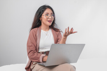 serious young asian business woman sitting down with a laptop while having discussion meeting, isola