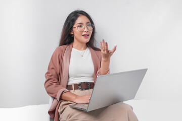 serious young asian business woman sitting down with a laptop while having discussion meeting, isola