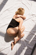 © Mallivan - Young sullen woman in lingerie lies on bed