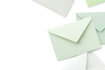 Wall Mural - pale green and white cutout envelopes are placed randomly, with copy space to the left.