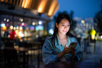 Poster - Woman use of mobile phone at outdoor in the evening time