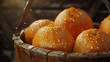 Fresh oranges are arranged in a wooden basket, with droplets of water glistening on their smooth skin. 
