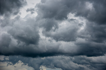 Wall Mural - dramatic blue-gray storm clouds are layered across the sky.