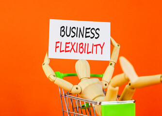 Business flexibility symbol. Concept words Business flexibility on beautiful white paper. Beautiful orange background. Businessman model in pushcart. Business flexibility concept. Copy space.