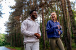 © DusanJelicic - Two friends running through a scenic forest path, sharing joy and fitness. Wearing hoodies and athletic gear, they highlight the importance of exercise and companionship.