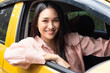 Happy smiling and relaxed woman driver driving with positive emotion, concept image for low reduced gasoline price, good traffic condition, new car, passing driver license, taxi app, Left-side driving