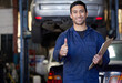 © peopleimages.com - Man, mechanic and thumbs up in workshop portrait, repair garage and automotive engineering for car maintenance. Good job, vehicle service and motor issues, confident employee and car lift for tuning