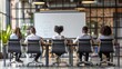 © photolas - A diverse group of young entrepreneurs sits at a table facing a whiteboard in a well-lit, contemporary office space, indicating an active discussion or brainstorming session.