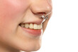 Closeup of a young smiling woman's visage with piercing septum hanging from her nose