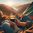 Coffee mug in the hands of a man sitting in a tent on the background of the mountains