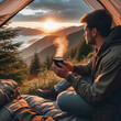 Man sitting in tent and drinking coffee in mountains at sunset. Travel and wanderlust concept