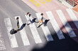 © peopleimages.com - Business, people and crosswalk from street to commute work, journey and traffic on road for transport in morning. Crowd, man and woman walking to travel, safety and trust to airport in Los Angeles