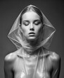 young Woman in transparent plastic dress with hood. black and white portrait of Beautiful Sexy Girl