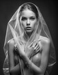 young Woman in transparent plastic dress with hood. black and white portrait of Beautiful Sexy Girl