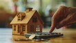 © Johannes - Calculators pressed by hand, aiming for home refinance. Wooden house model, buy or rent note. Concept of saving for property, strategic mortgage payment. Tax, credit analysis for financial success.