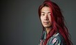 © TheoTheWizard - Portrait of young Asian man with deep red long hair in traditional clothes looking at camera
