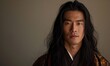 © TheoTheWizard - Portrait of young Asian man with dark long hair in traditional clothes looking at camera