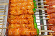 grilled chicken skewers with sweet sauce on food stall, selective focus