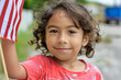 © Ikram - Happy child waving American flag, Memorial Day joy.