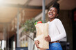 © peopleimages.com - Bag, groceries and black woman for shopping, outside and vegetables for healthy food. Face, smile and happy for promo and discount on sale for produce, female person and customer in city supermarket