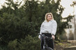 Woman Standing Next to Bike in Park