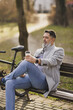 Man Sitting and Relaxing on a Park Bench