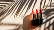 lipsticks on a minimalist surface with shadow of palm trees