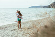 Mom Embracing the Teen Girl on the Sandy Beach