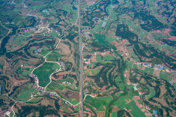 Wall Mural -  aerial view of farm field and village in spring
